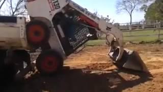 Mini tractor backhoe loader loads itself to the truck